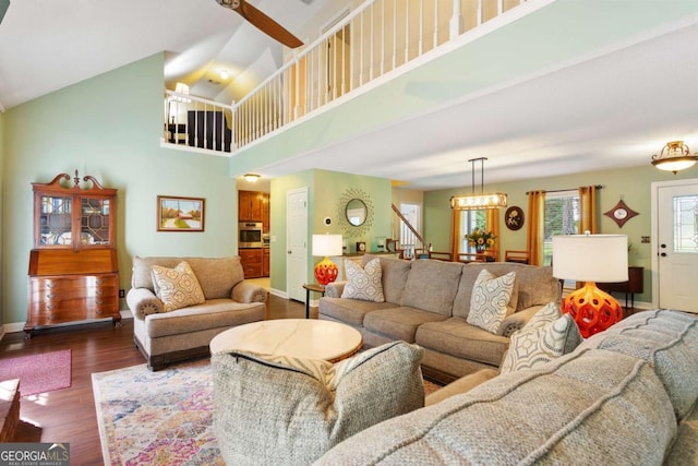 836 Palmetto Tyrone Rd, Sharpsburg, GA 30277 - living room with high vaulted ceiling, dark wood finished floors, stairway, baseboards, and a chandelier