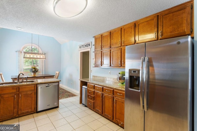 836 Palmetto Tyrone Rd, Sharpsburg, GA 30277 - kitchen with stainless steel appliances, a sink, brown cabinets, a textured ceiling, and light tile patterned floors