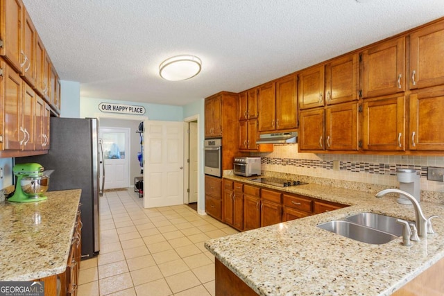 836 Palmetto Tyrone Rd, Sharpsburg, GA 30277 - kitchen with stainless steel appliances, under cabinet range hood, a sink, light tile patterned flooring, and a peninsula