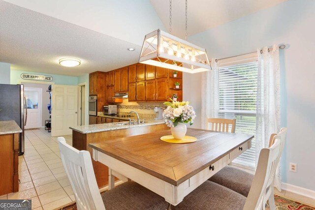 836 Palmetto Tyrone Rd, Sharpsburg, GA 30277 - dining space featuring light tile patterned floors, vaulted ceiling, and baseboards