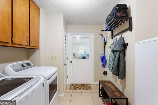 836 Palmetto Tyrone Rd, Sharpsburg, GA 30277 - clothes washing area featuring washer and clothes dryer, cabinet space, a textured ceiling, light tile patterned floors, and baseboards