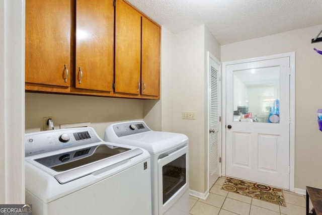 836 Palmetto Tyrone Rd, Sharpsburg, GA 30277 - laundry room featuring washer and clothes dryer, light tile patterned flooring, cabinet space, a textured ceiling, and baseboards