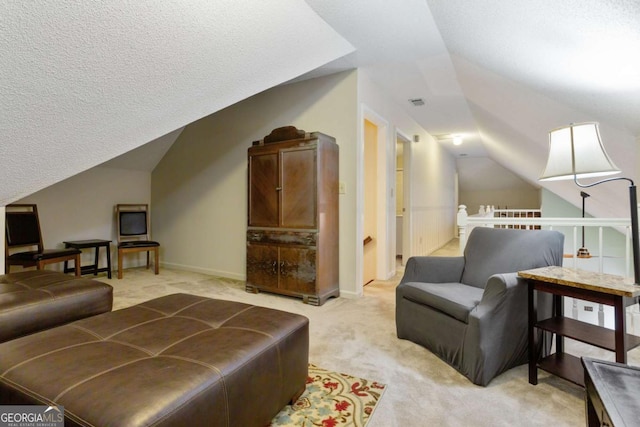 836 Palmetto Tyrone Rd, Sharpsburg, GA 30277 - living area with lofted ceiling, light colored carpet, baseboards, and a textured ceiling