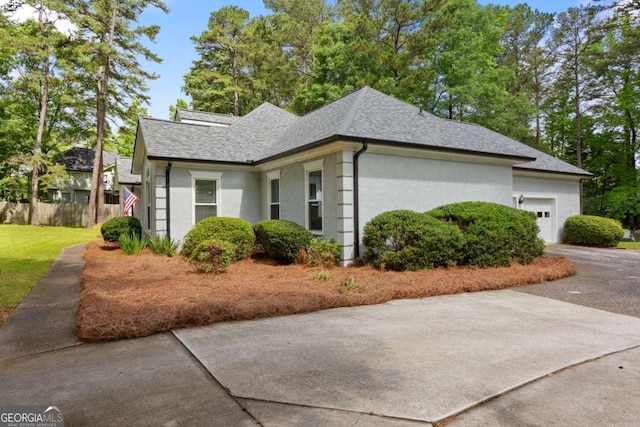 836 Palmetto Tyrone Rd, Sharpsburg, GA 30277 - view of home's exterior featuring an attached garage, a shingled roof, concrete driveway, and stucco siding