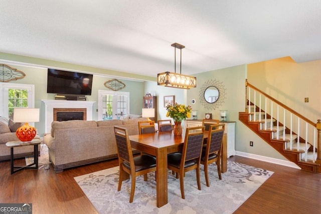 836 Palmetto Tyrone Rd, Sharpsburg, GA 30277 - dining space featuring stairs, wood finished floors, a fireplace, and baseboards