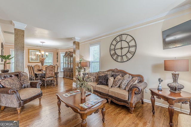 5342 Lakerock Dr SW, South Fulton, GA 30331 - living area with a chandelier, crown molding, wood finished floors, and healthy amount of natural light