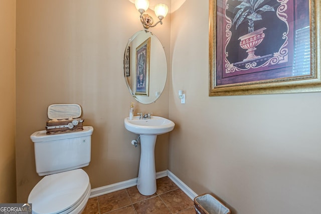 5342 Lakerock Dr SW, South Fulton, GA 30331 - half bath with baseboards, toilet, tile patterned flooring, and a sink