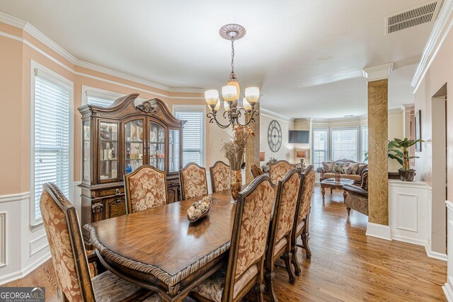5342 Lakerock Dr SW, South Fulton, GA 30331 - dining room with a chandelier, light wood-style floors, crown molding, and wainscoting