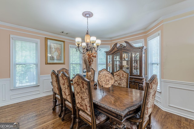 5342 Lakerock Dr SW, South Fulton, GA 30331 - dining space with a chandelier, wood finished floors, a wainscoted wall, a decorative wall, and ornamental molding