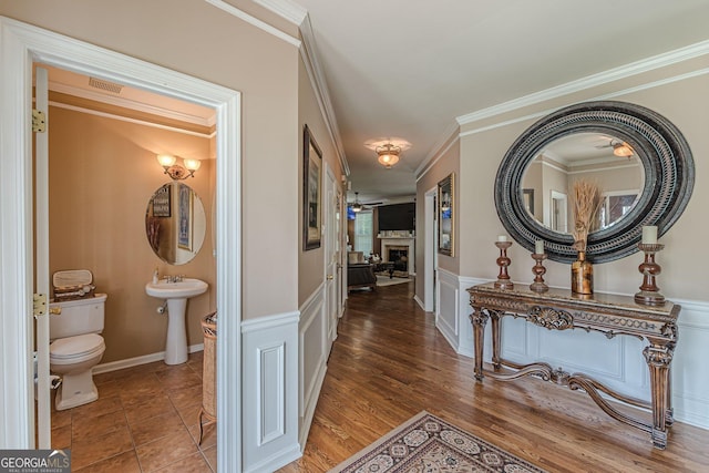 5342 Lakerock Dr SW, South Fulton, GA 30331 - hall featuring a wainscoted wall, crown molding, a sink, a decorative wall, and wood finished floors
