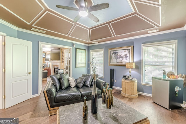 5342 Lakerock Dr SW, South Fulton, GA 30331 - living area with ceiling fan, a glass covered fireplace, crown molding, healthy amount of natural light, and baseboards
