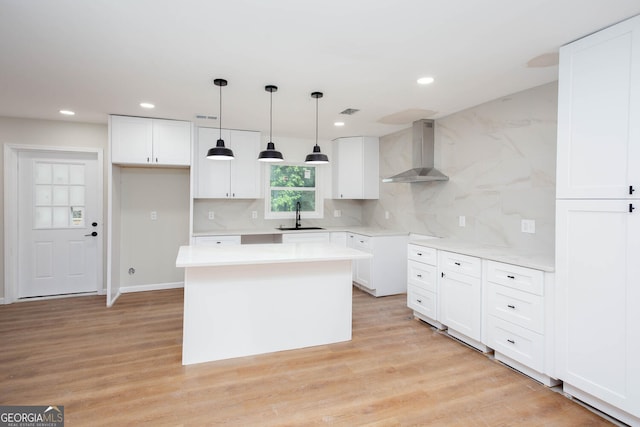 2131 Glendale Dr, Decatur, GA 30032 - kitchen with wall chimney exhaust hood, a sink, tasteful backsplash, light wood-style flooring, and recessed lighting