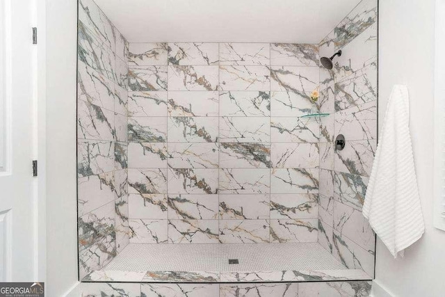 full bath featuring a tile shower