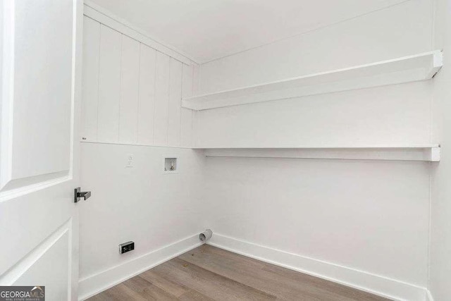laundry area with wood finished floors, baseboards, and washer hookup
