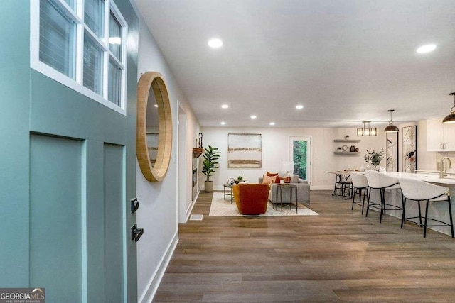 entryway featuring recessed lighting, dark wood-style floors, and baseboards
