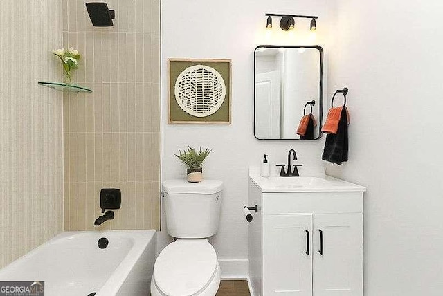 bathroom featuring toilet, vanity, and shower / bath combination