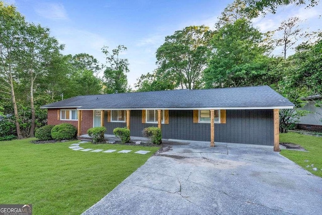 ranch-style home featuring a porch, concrete driveway, and a front yard