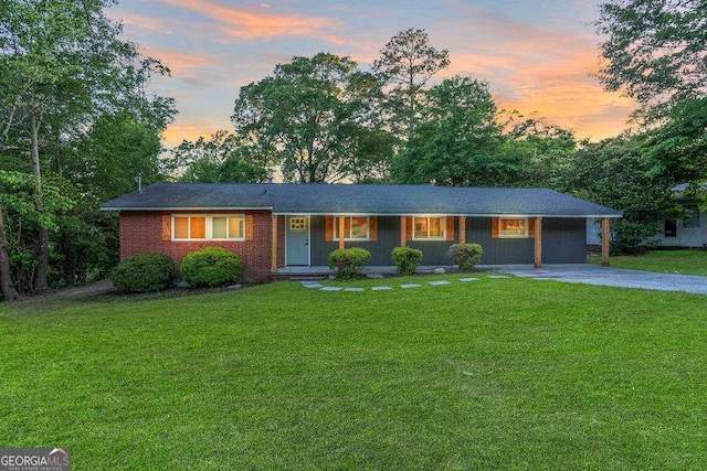 ranch-style house with a front yard and driveway