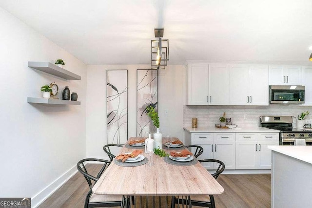 dining area with light wood-style floors and baseboards