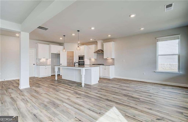 242 Linford Dr, Locust Grove, GA 30248 - kitchen with tasteful backsplash, wall chimney range hood, light wood-type flooring, white cabinets, and recessed lighting