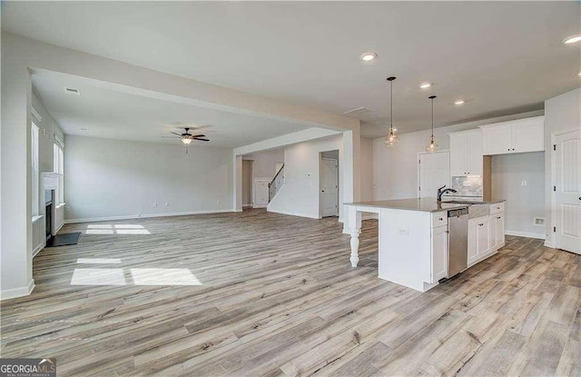 242 Linford Dr, Locust Grove, GA 30248 - kitchen featuring stainless steel dishwasher, light wood finished floors, white cabinetry, and recessed lighting