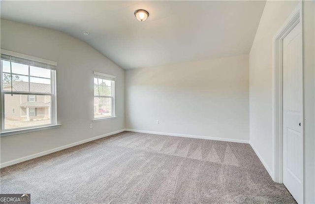 242 Linford Dr, Locust Grove, GA 30248 - spare room featuring lofted ceiling and carpet