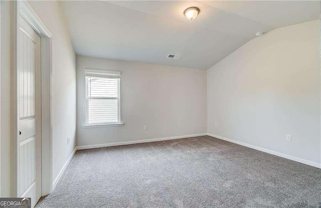 242 Linford Dr, Locust Grove, GA 30248 - carpeted empty room featuring vaulted ceiling and baseboards