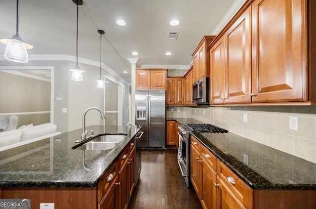 kitchen featuring appliances with stainless steel finishes, a sink, ornamental molding, brown cabinetry, and recessed lighting