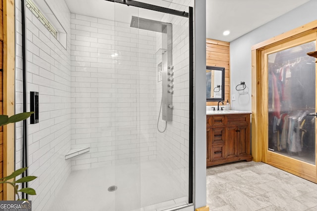 bathroom with a stall shower, vanity, stone finish flooring, and recessed lighting