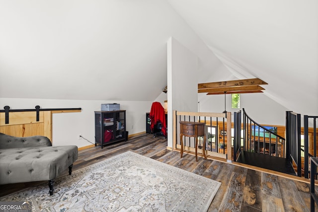 living area with wood finished floors, an upstairs landing, vaulted ceiling, and baseboards