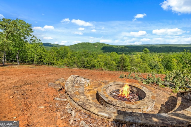 view of mountain backdrop featuring a forest