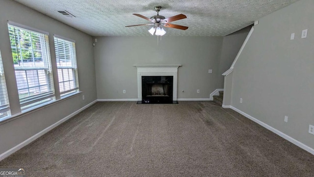 2153 Pine View Trl, Ellenwood, GA 30294 - unfurnished living room featuring a ceiling fan, a high end fireplace, a textured ceiling, stairway, and carpet flooring