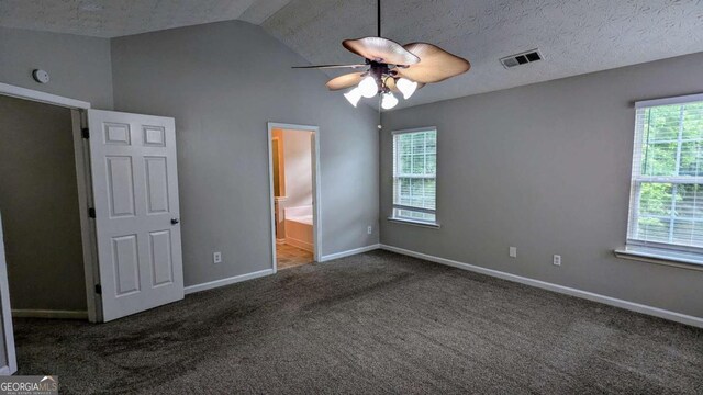 2153 Pine View Trl, Ellenwood, GA 30294 - unfurnished bedroom featuring carpet flooring, lofted ceiling, ensuite bathroom, a ceiling fan, and a textured ceiling
