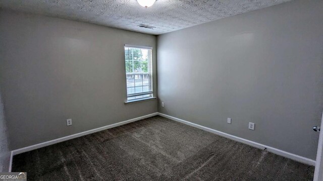 2153 Pine View Trl, Ellenwood, GA 30294 - spare room featuring carpet flooring and a textured ceiling