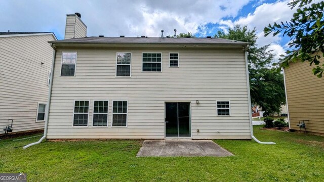 2153 Pine View Trl, Ellenwood, GA 30294 - rear view of property featuring a patio, a lawn, and a chimney