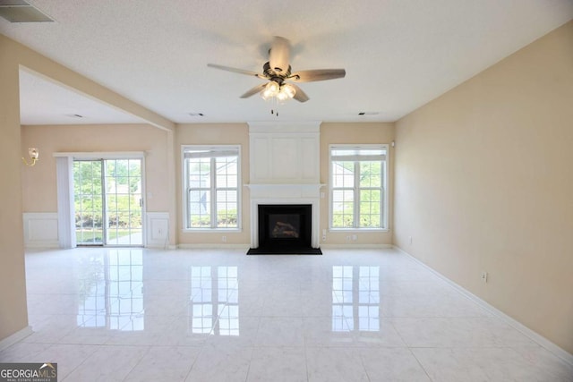 3601 Gainesway Trce, Duluth, GA 30096 - unfurnished living room with plenty of natural light, a ceiling fan, a large fireplace, and baseboards
