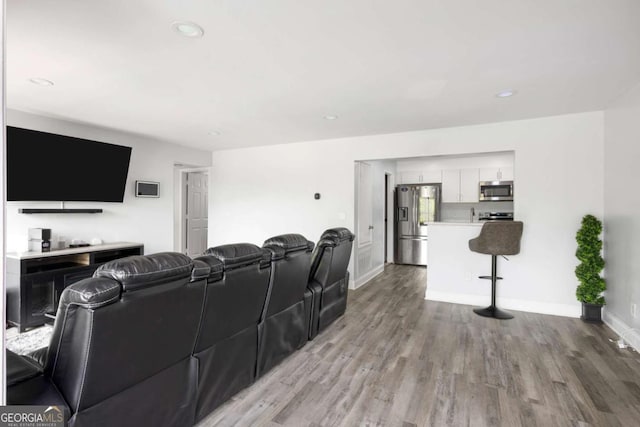 home theater room with light wood-type flooring, baseboards, and recessed lighting