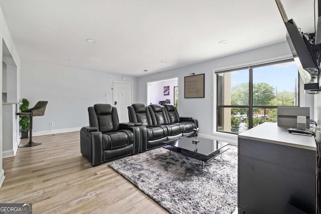 cinema room featuring light wood-style flooring, baseboards, and recessed lighting