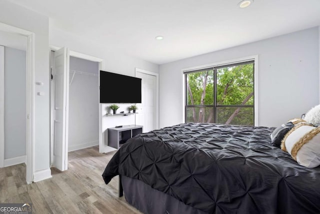 bedroom with light wood-style flooring, recessed lighting, and baseboards