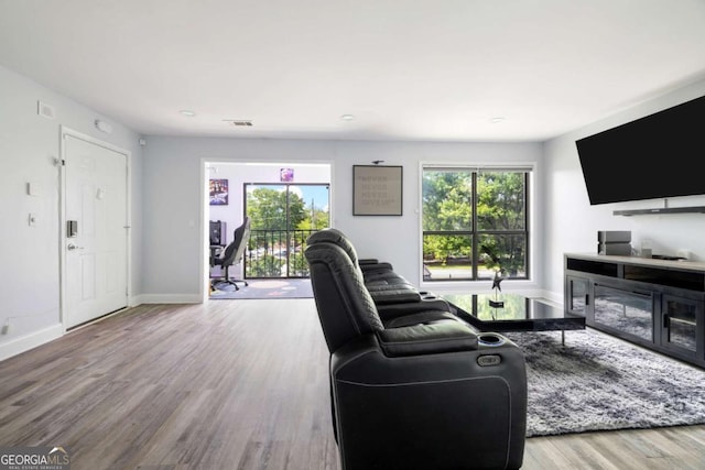living area with wood finished floors and baseboards