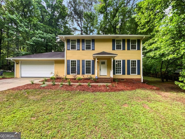 colonial house featuring concrete driveway, an attached garage, and a front yard