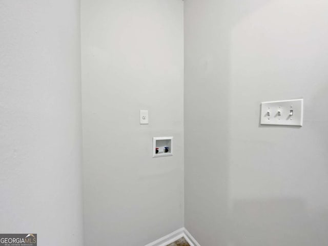 laundry room with hookup for a washing machine and baseboards