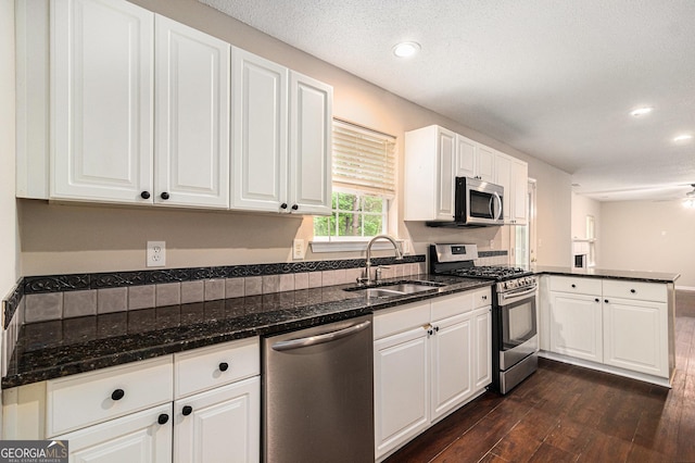4615 Thermal Ct, Douglasville, GA 30135 - kitchen featuring stainless steel appliances, a sink, dark wood-style flooring, white cabinetry, and recessed lighting