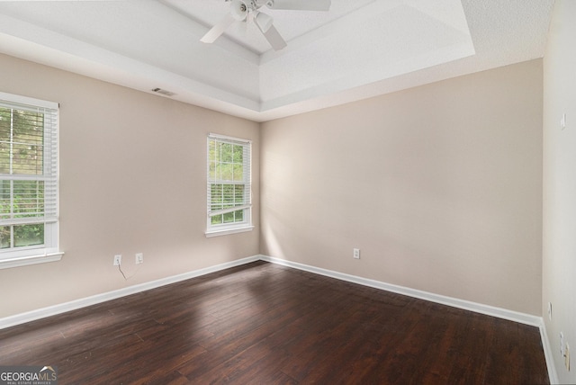 4615 Thermal Ct, Douglasville, GA 30135 - spare room featuring a raised ceiling, dark wood-style flooring, baseboards, and a ceiling fan