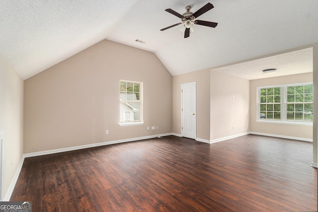4615 Thermal Ct, Douglasville, GA 30135 - unfurnished living room featuring dark wood-style flooring, a ceiling fan, vaulted ceiling, and baseboards