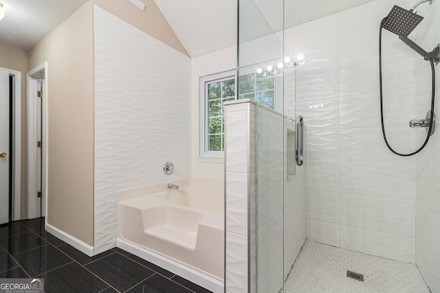 4615 Thermal Ct, Douglasville, GA 30135 - full bathroom featuring tile patterned flooring, a stall shower, a bath, vaulted ceiling, and baseboards