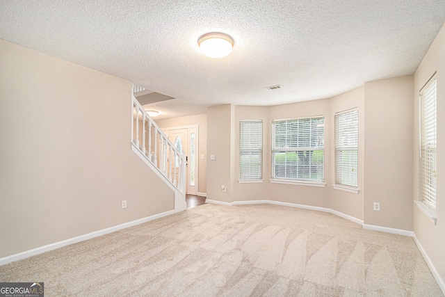 4615 Thermal Ct, Douglasville, GA 30135 - empty room with stairs, carpet floors, a textured ceiling, and baseboards