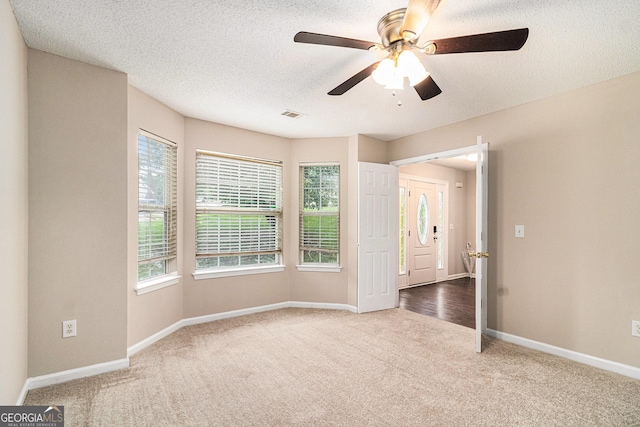 4615 Thermal Ct, Douglasville, GA 30135 - unfurnished room featuring carpet flooring, plenty of natural light, baseboards, ceiling fan, and a textured ceiling