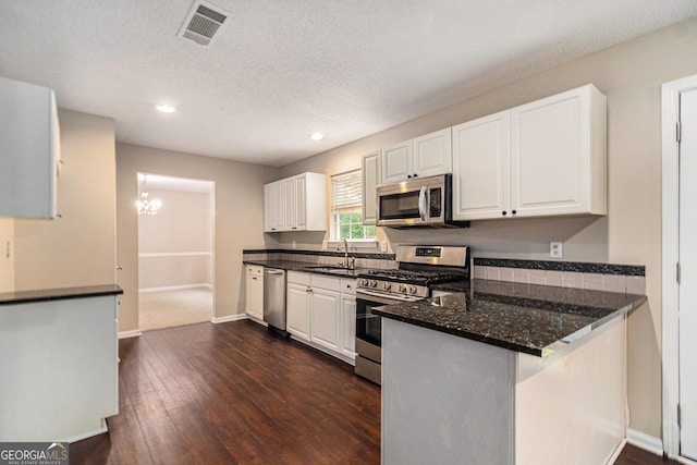 4615 Thermal Ct, Douglasville, GA 30135 - kitchen featuring stainless steel appliances, white cabinetry, dark wood finished floors, a peninsula, and recessed lighting