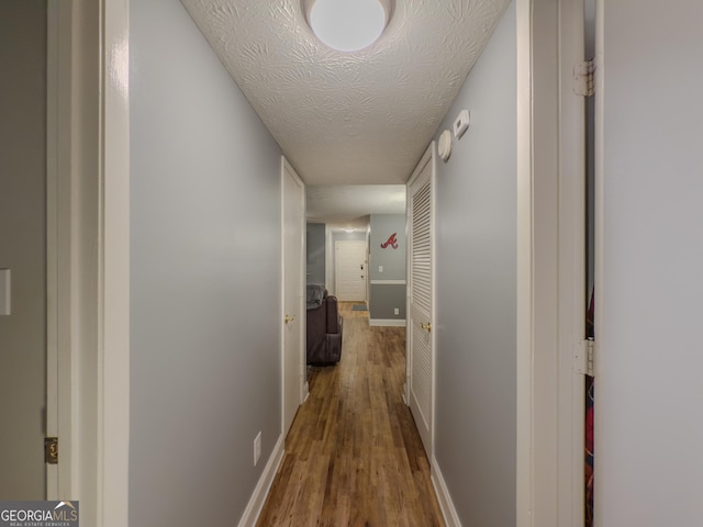 2610 Cumberland Ct, Smyrna, GA 30080 - hall with wood finished floors, baseboards, and a textured ceiling
